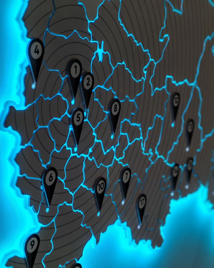 our-story Illuminated map with location pins and blue LED background lighting.